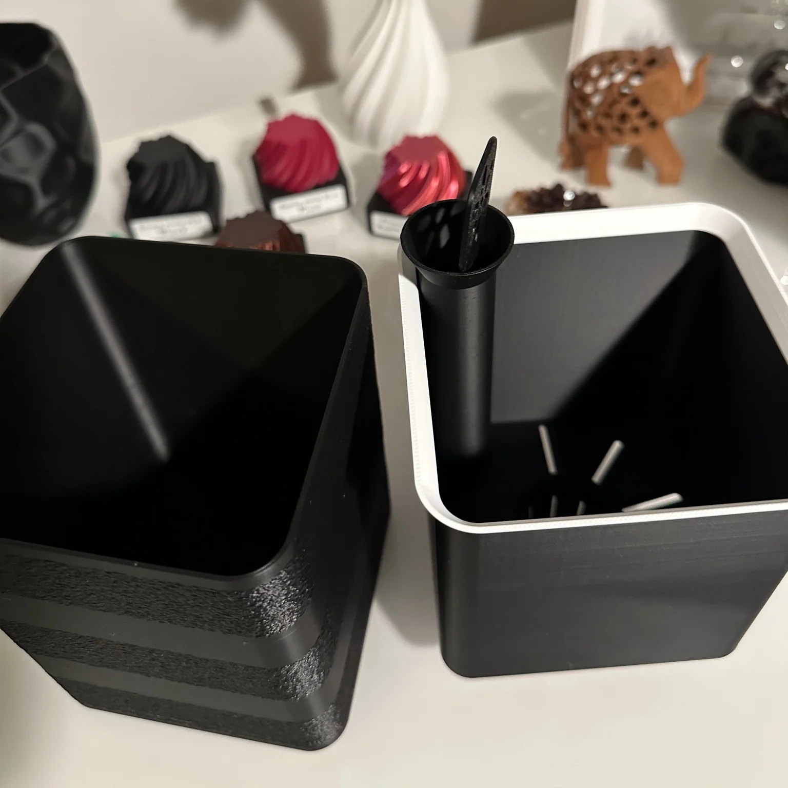 The modular pot's inner and outer containers shown separately, with the watering tube in place